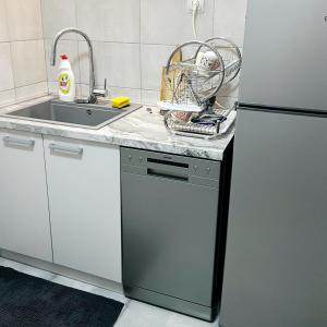 a kitchen with a sink and a dishwasher at Andrej's Village House 