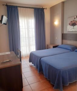 Ένα ή περισσότερα κρεβάτια σε δωμάτιο στο Hostal La Colonia