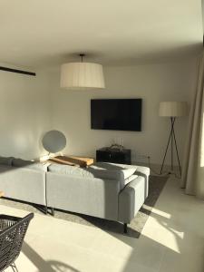 A television and/or entertainment centre at New apartment in Higueron West