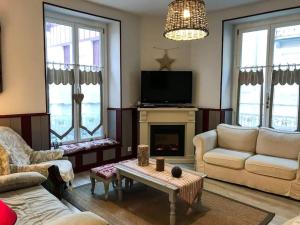 a living room with a couch and a fireplace at Centre Cauterets, appartement 72m2 pr 7 personnes in Cauterets