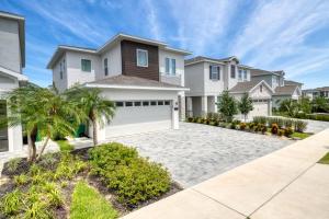 a large white house with a garage at Encore Resort and Water Park at Reunion by Rentyl in Kissimmee