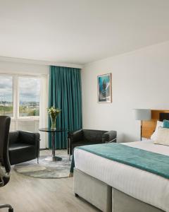 a hotel room with a bed and a window at Langstone Quays Resort, Portsmouth in Portsmouth