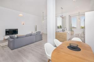 a living room and kitchen with a table and a couch at Homey apt Cómpeta in Cómpeta