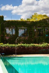a house with a swimming pool in front of a building at Hotel Rural Casa Pernías in Moratalla