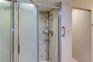 a shower with a glass door in a bathroom at Isle of Pines in Hilton Head Island