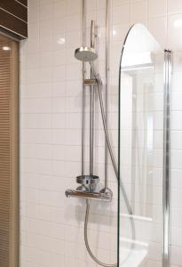 a shower in a bathroom with a glass door at 2ndhomes Luxury Helsinki Center 2BR Apartment with Sauna in Helsinki