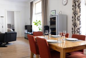 a dining room with a wooden table and chairs at 2ndhomes Luxury Helsinki Center 2BR Apartment with Sauna in Helsinki