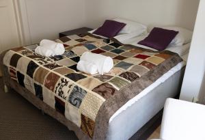 a bed with two pillows and a quilt on it at 2ndhomes Luxury Helsinki Center 2BR Apartment with Sauna in Helsinki