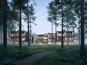 um edifício no meio de uma floresta com árvores em Marina Maisonette Seeblick mit Pool und Sauna em Bad Saarow