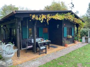 a pergola with a table on a wooden deck at My Happy Garden 1500sq m in Ochsenfurt