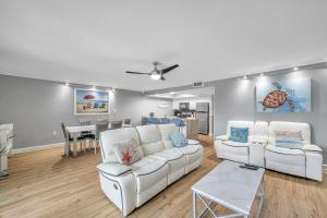 a living room with two white couches and a table at Holiday Villas 2 104 in Clearwater Beach