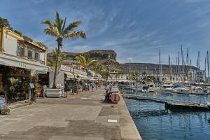 a marina with boats in the water and palm trees at Malibú Mogán Casita Bonsai - Wifi & Beach Studio in Puerto de Mogán