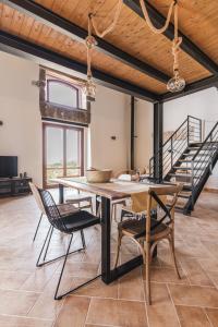 a dining room with a table and chairs and a staircase at Alla Riserva - Villa Riserva dello Zingaro - Scopello in Scopello +44 photos