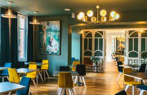 a restaurant with tables and chairs and a painting on the wall at Mayrena Hotel Restaurant in Eu