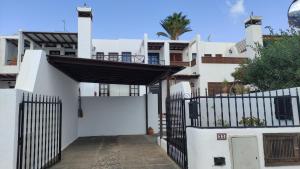 a white house with a gate and a fence at Casa Marina in Tías