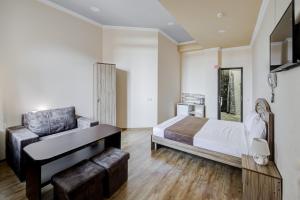 a bedroom with a bed and a desk and a chair at H Resort Hotel Vagharshapat Armenia in Vagharshapat