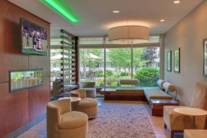 a lobby with a waiting room with a couch and chairs at Holiday Inn Bangor by IHG in Bangor