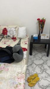 a woman laying on a bed in a room at Adex Cool Apartment in Abu Dhabi