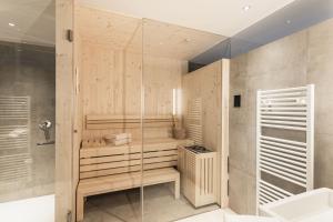 a bathroom with a shower and a glass wall at Aquila Dolomites Residence in Ortisei +75 photos