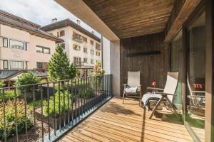 a patio area with a patio table and chairs at Aquila Dolomites Residence in Ortisei