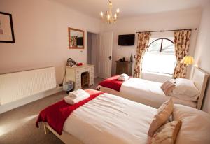 Katil atau katil-katil dalam bilik di Manor House Inn
