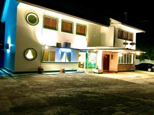 a white house with a car parked in front of it at Art Heritage at Lucky 7 in Ipoh