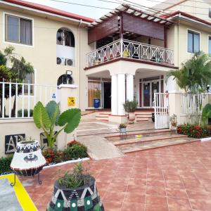 a house with a courtyard and a balcony at Asantewaa Premier Hotel in Kumasi