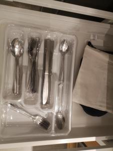 a plastic tray with forks and spoons and a napkin at Jimmy B&B in Surrey