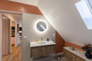 a bathroom with a sink and a mirror at Soft time - Luxury flat - Historic Centre Honfleur in Honfleur