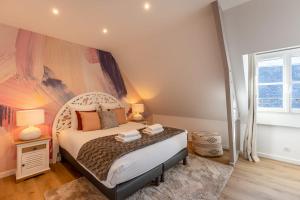 a bedroom with a bed and a large window at Soft time - Luxury flat - Historic Centre Honfleur in Honfleur