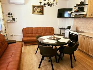 a living room with a table and chairs and a couch at Turul -Kuća za odmor- in Korođ