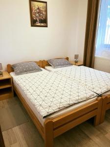 a bedroom with a large bed with a white comforter at Turul -Kuća za odmor- in Korođ