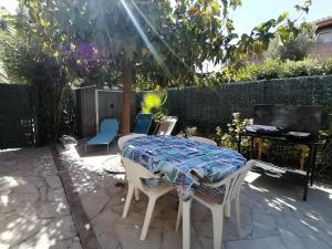 eine Terrasse mit einem Tisch, Stühlen und einem Klavier in der Unterkunft LE SOLEIL D'OR in Sainte-Maxime