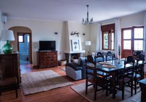 a living room with a dining room table and chairs at Casa Ferradal in Quintanilha