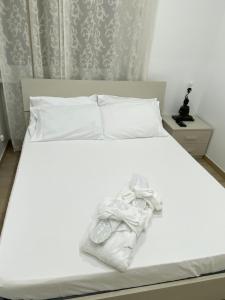 a white bed with a white towel on it at Le bougainvillea 2 in Corbetta