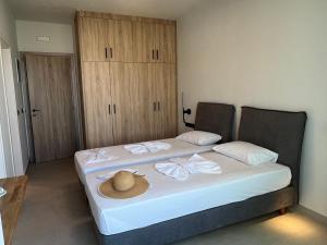 a bedroom with a bed with a hat on it at Hotel Kathrin Beach in Adelianos Kampos