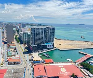 an aerial view of a city and the ocean at Jesselton Quay KK SEA VIEW or CITY VIEW by LOVIA in Kota Kinabalu