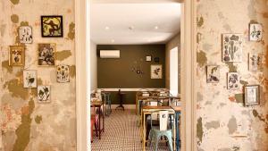 a dining room with a table and some pictures on the walls at Casa do Jasmim by Shiadu in Lisbon
