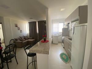 a kitchen and a living room with a refrigerator at Apartamento Prox. Unievangelica 201 in Anápolis