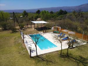 an overhead view of a swimming pool in a field at Cabañas Tierra del Sol in Las Rabonas