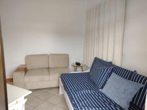 sala de estar con cama y sofá en Pousada Vale Del Sol, en Bombinhas