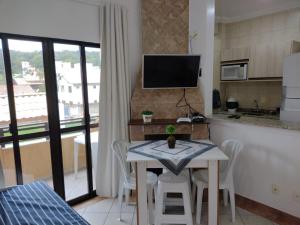 a kitchen and dining room with a table and chairs at Pousada Vale Del Sol in Bombinhas