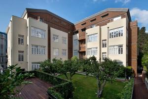 an apartment building with trees in the courtyard at The Norman Tel Aviv in Tel Aviv