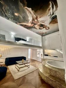 a living room with a painting on the ceiling at Loft City View in Budapest +63 photos