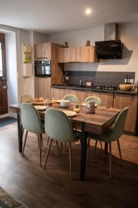 a dining room table and chairs in a kitchen at *OKALEE* in Dinan