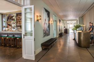 a room with a bar with a bench and a table at The Norman Tel Aviv in Tel Aviv