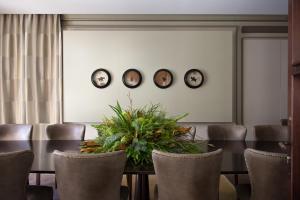 a dining room with a table and four plates on the wall at The Norman Tel Aviv in Tel Aviv