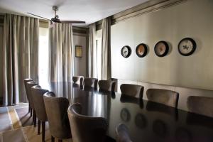 a conference room with chairs and clocks on the wall at The Norman Tel Aviv in Tel Aviv