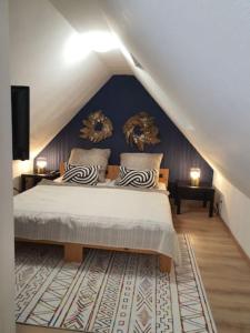 a bedroom with a large bed in a attic at Beautiful Cozy apartments close to lakes and nature parks in Schwandorf in Bayern