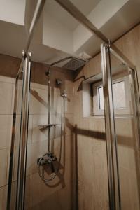 a shower with a glass door in a bathroom at Apartamentul Galben in Vatra Dornei